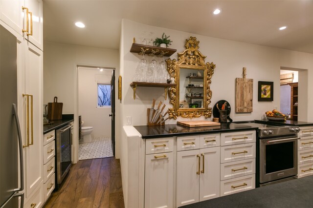 kitchen featuring white cabinetry, high end range, beverage cooler, and dark hardwood / wood-style floors