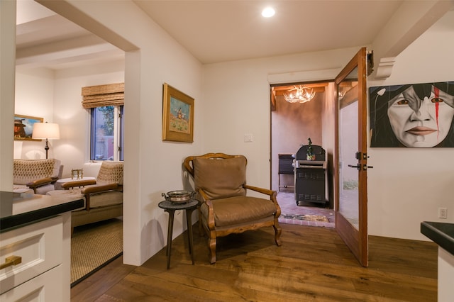 sitting room with dark wood-type flooring