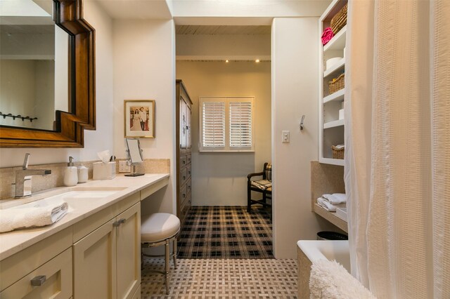 bathroom with tile patterned flooring and vanity