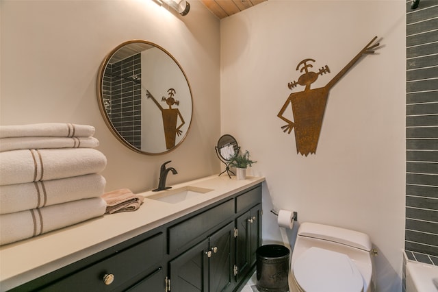 bathroom featuring a bathing tub, vanity, and toilet