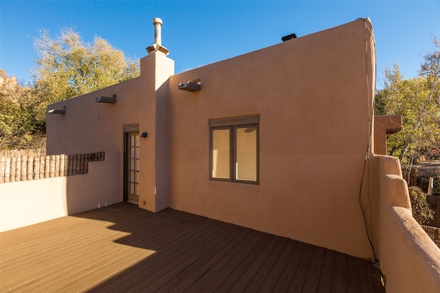 back of property featuring a wooden deck