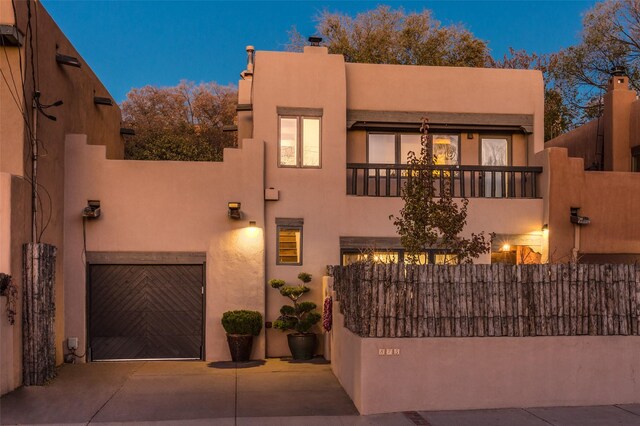 patio terrace at dusk featuring an outdoor living space with a fireplace