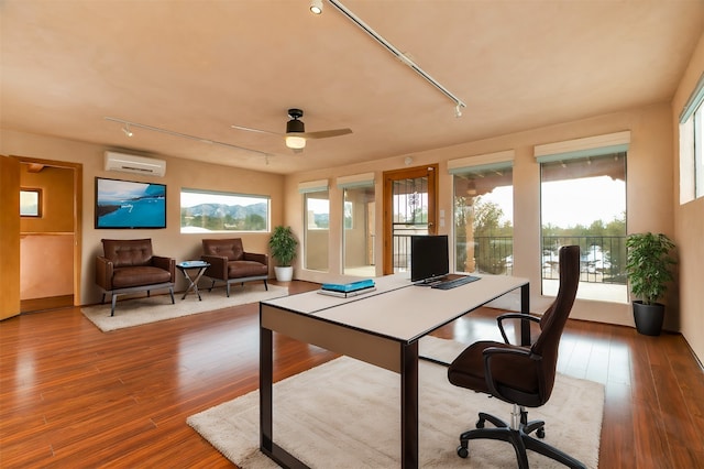 office space featuring hardwood / wood-style floors, a wealth of natural light, and a wall mounted AC