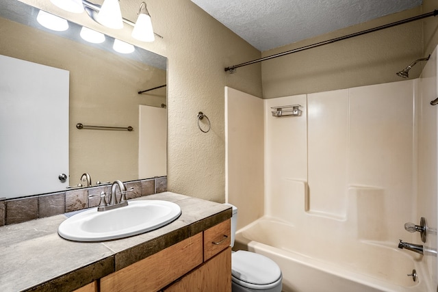 full bathroom featuring bathtub / shower combination, vanity, a textured ceiling, and toilet