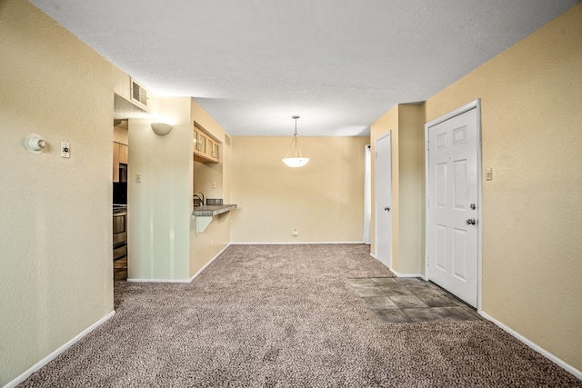 unfurnished room featuring dark carpet and sink