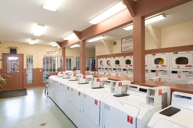 laundry area featuring washer and clothes dryer, stacked washer / dryer, and a textured ceiling