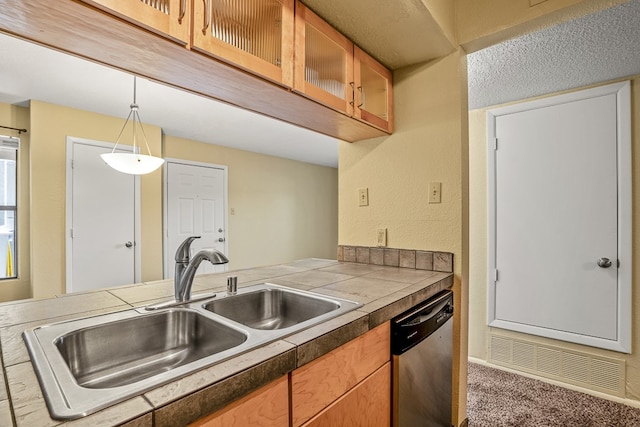 kitchen with carpet, pendant lighting, stainless steel dishwasher, and sink