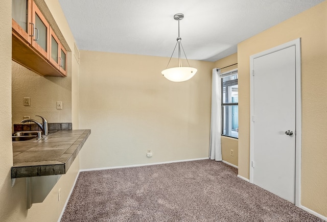 unfurnished dining area with carpet flooring and sink