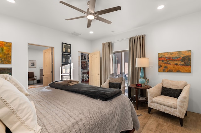 bedroom with light hardwood / wood-style floors and ceiling fan