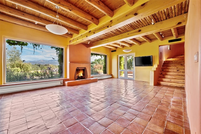 view of patio featuring french doors, a large fireplace, and baseboard heating