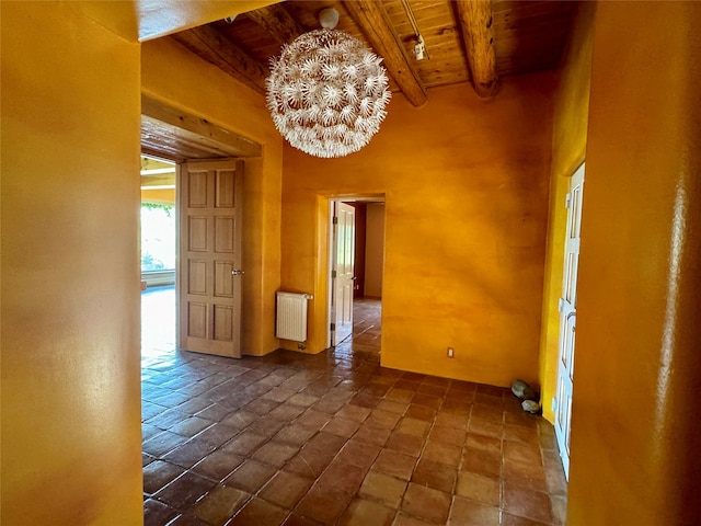 tiled empty room featuring beam ceiling, radiator heating unit, wooden ceiling, and a notable chandelier