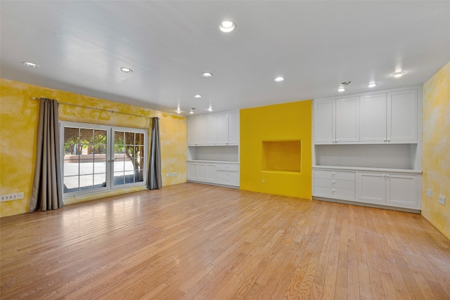 unfurnished living room featuring light wood-type flooring