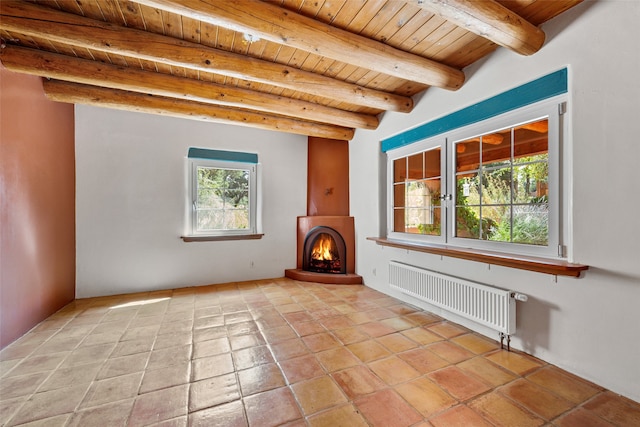 unfurnished living room with beam ceiling, radiator, and wooden ceiling