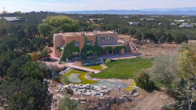 birds eye view of property with a mountain view