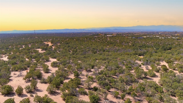 aerial view at dusk featuring a mountain view