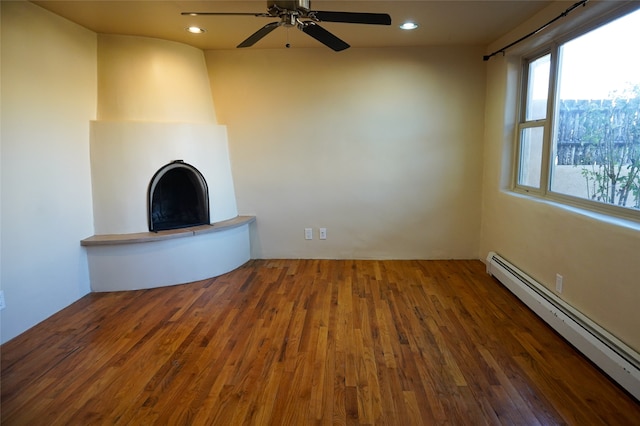 unfurnished living room featuring a fireplace, ceiling fan, dark wood-type flooring, and a baseboard radiator