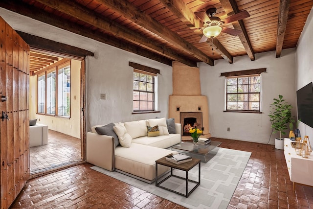 living room featuring a healthy amount of sunlight, wood ceiling, and beam ceiling