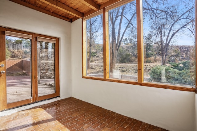 unfurnished sunroom with beamed ceiling and wood ceiling