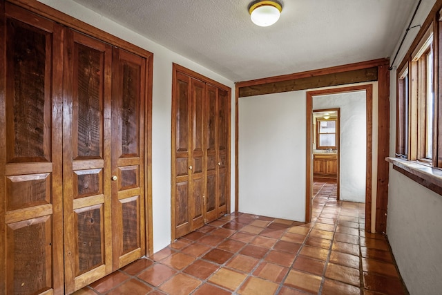 hall featuring a textured ceiling