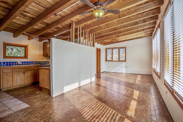 kitchen featuring vaulted ceiling with beams, ceiling fan, wooden ceiling, and decorative backsplash