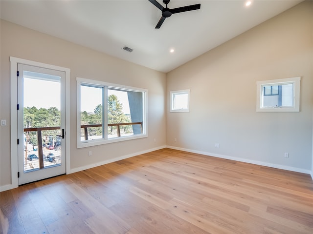 unfurnished room with ceiling fan, light hardwood / wood-style floors, and vaulted ceiling