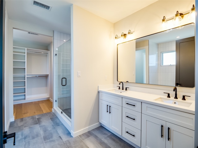 bathroom featuring vanity, wood-type flooring, and walk in shower