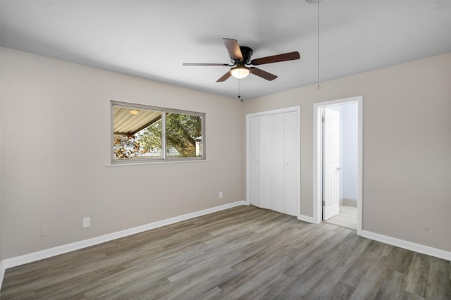 unfurnished bedroom with hardwood / wood-style flooring and ceiling fan