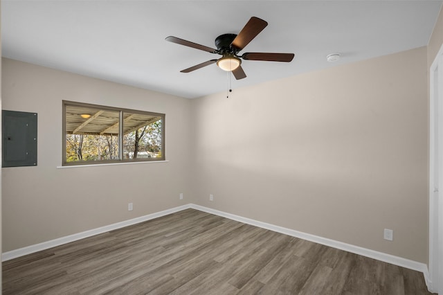 unfurnished room featuring electric panel, ceiling fan, and wood-type flooring