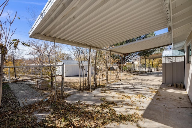 view of patio featuring a storage unit