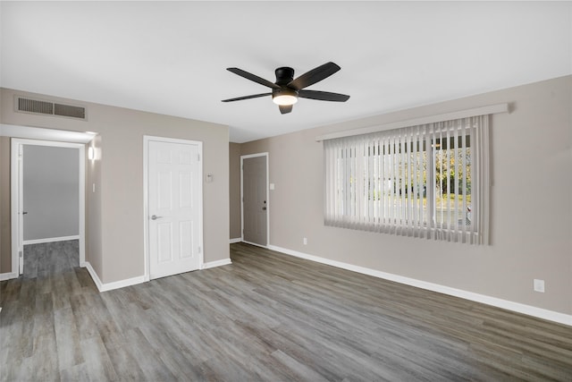 unfurnished bedroom featuring hardwood / wood-style flooring, ceiling fan, and a closet