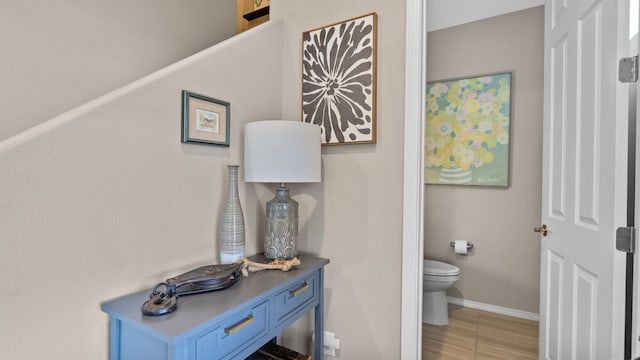 bathroom featuring tile patterned floors, toilet, and baseboards