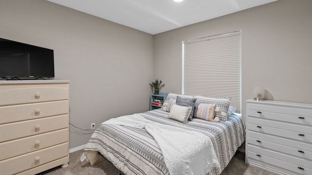 carpeted bedroom featuring baseboards