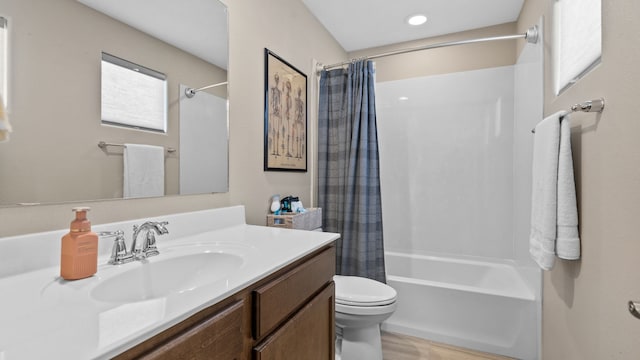 bathroom with shower / bath combo with shower curtain, toilet, wood finished floors, and vanity