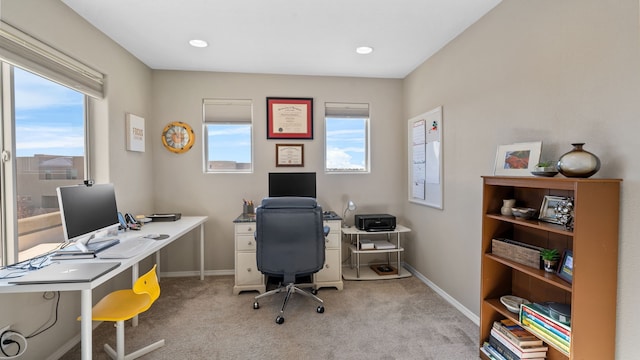 office with light carpet, baseboards, and a wealth of natural light