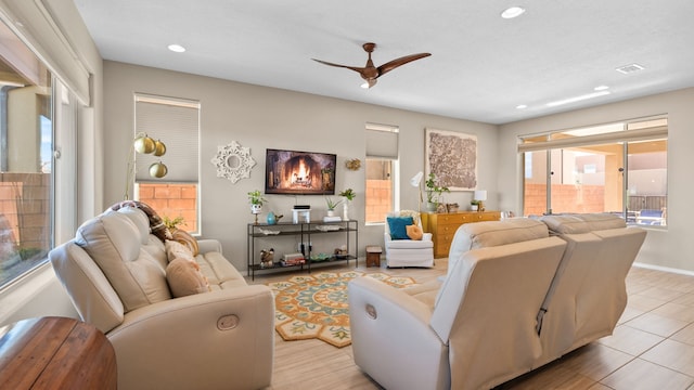 tiled living room featuring ceiling fan