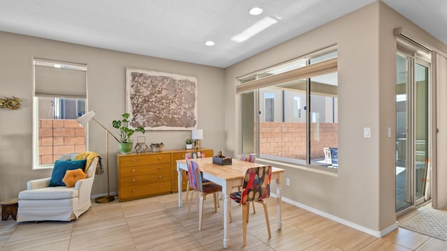 dining space with recessed lighting, baseboards, and a healthy amount of sunlight