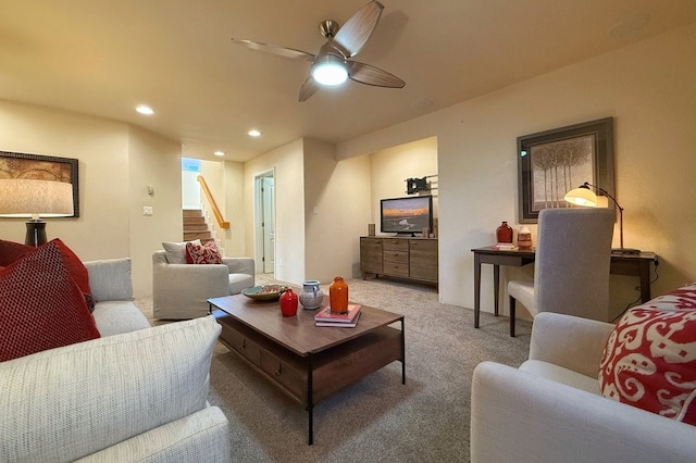 carpeted living room featuring ceiling fan