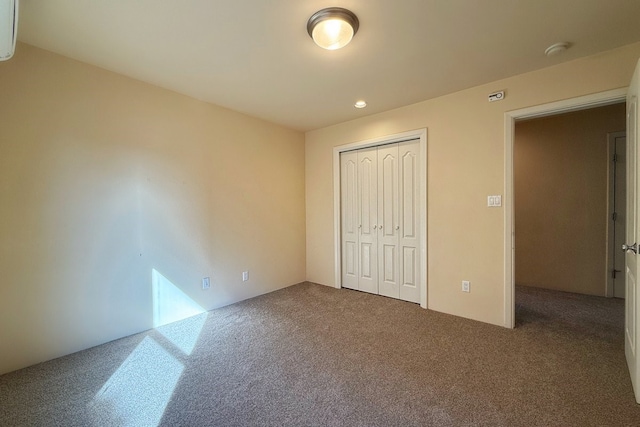 unfurnished bedroom with carpet and a closet