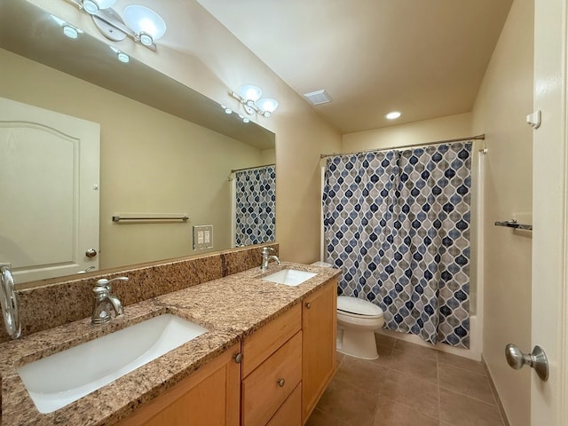 bathroom featuring tile patterned flooring, vanity, and toilet