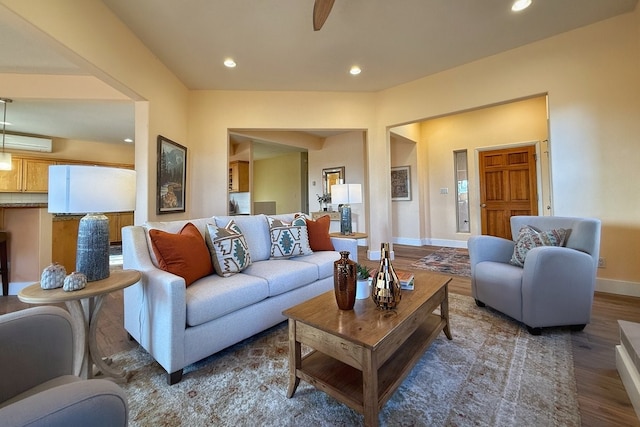 living room featuring a wall mounted AC and hardwood / wood-style floors