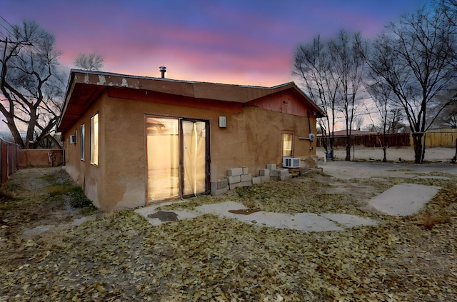 view of back house at dusk