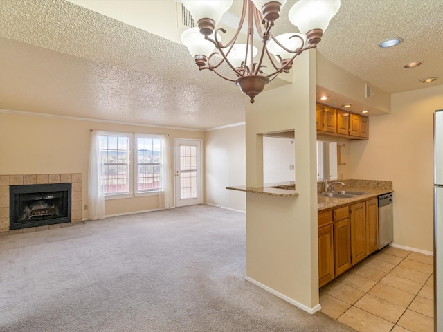 kitchen featuring a textured ceiling, light colored carpet, and sink