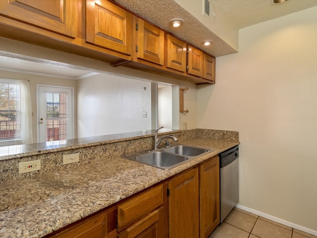 kitchen with light stone countertops, sink, stainless steel dishwasher, a textured ceiling, and light tile patterned floors