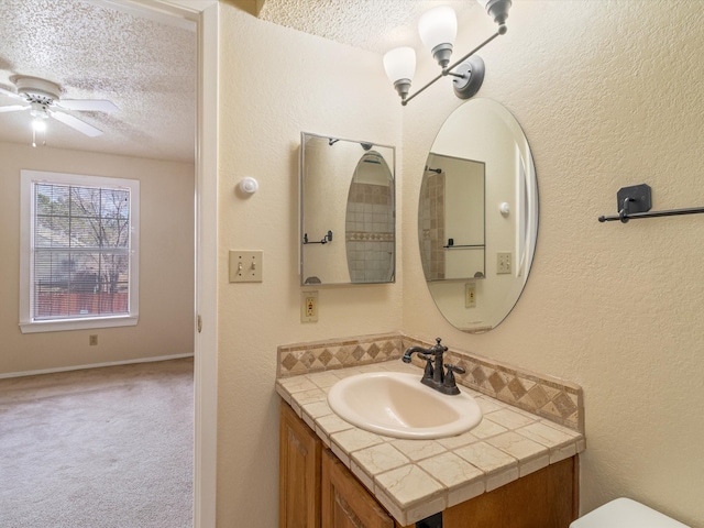 bathroom with vanity, a textured ceiling, and ceiling fan