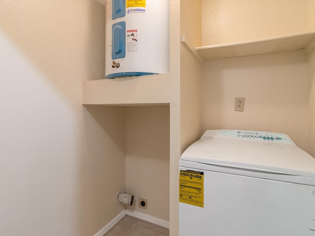 washroom featuring washer / dryer, light tile patterned floors, and water heater