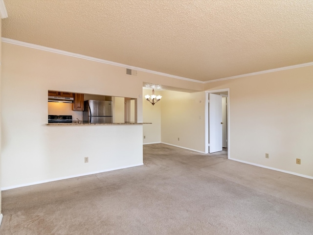 unfurnished living room with a textured ceiling, ornamental molding, and light carpet