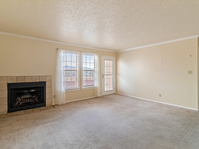 unfurnished living room featuring a textured ceiling, carpet flooring, crown molding, and a fireplace