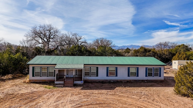 view of front of house with covered porch and a mountain view