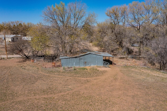 view of yard featuring an outbuilding and a rural view