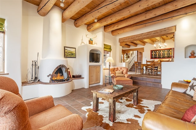 living room with tile patterned floors, beam ceiling, wood ceiling, and a large fireplace